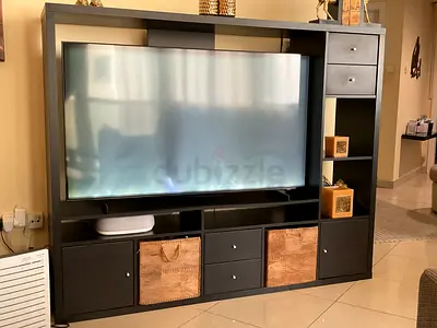 Dark wood entertainment center with shelves and drawers