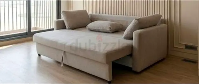 Light beige pull-out sofa bed with storage, good condition very comfortable home delivery available