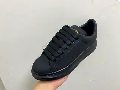Alagnder mcqeen Black leather low-top sneakers with gold logo - size available