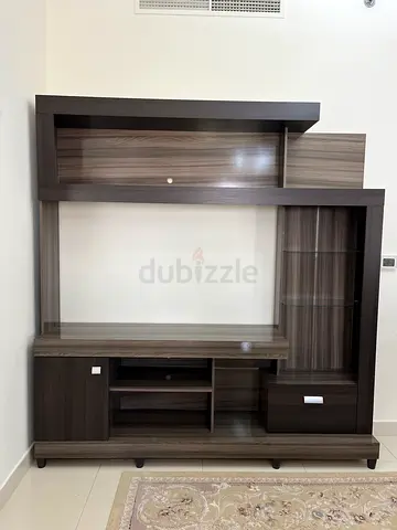 Modern dark wood TV entertainment unit with shelves and drawers