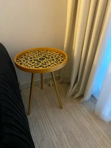 Round decorative side table with patterned top - gold finish