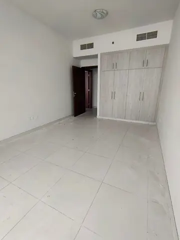 Two bedrooms and a living room for annual rent in Al Rashidiya 3 – next to Grand Mall, with free parking and air conditioning.