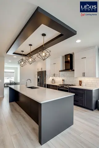 Modern kitchen island with pendant lights and white quartz countertop