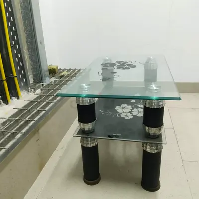 Glass coffee table with floral print and two-tier storage