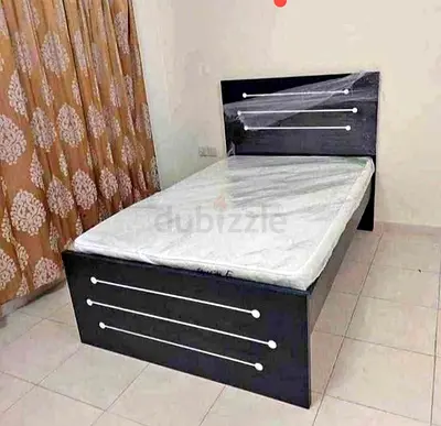 Single wooden bed frame with headboard and mattress