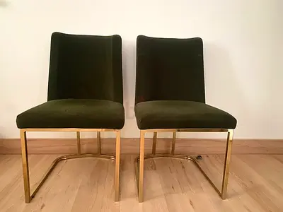 Pair of olive green velvet dining chairs with gold metal frames