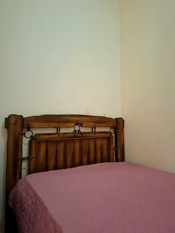 Solid wooden single bed frame with rustic headboard