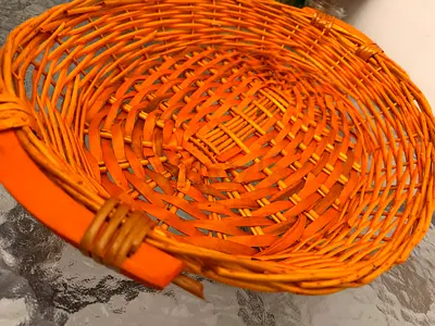 Small woven wicker basket with handle