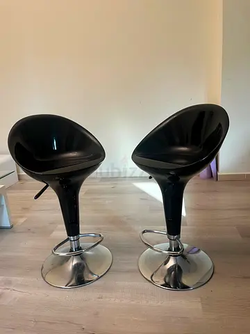 Pair of modern black swivel bar stools with chrome base