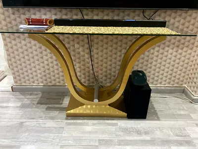 Glass top console table with gold curved base - good condition