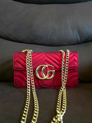 Red quilted mini shoulder bag with gold chain strap