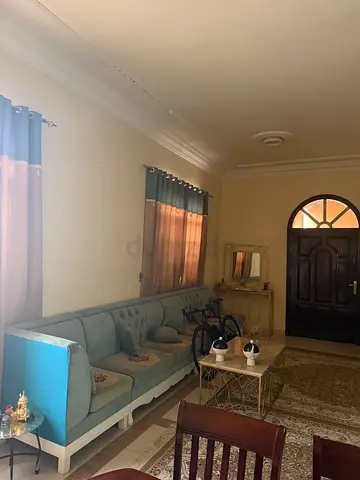 Light blue L-shaped fabric sofa in good condition