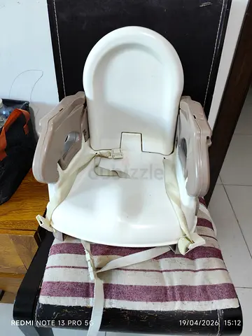 Portable booster/high chair seat with safety straps — used