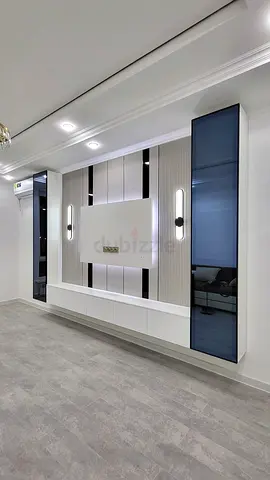 Modern built-in entertainment wall unit with storage and lighting