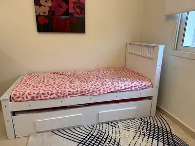 Wooden Storage Cabinet with Three Doors along with 2 single beds