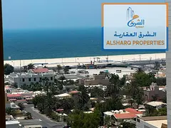 A luxurious two-bedroom apartment with a large living room and a sea view, located in one of the fin