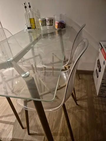Glass dining table with 4 modern clear chairs - good condition