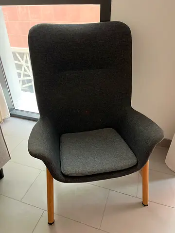 Ikea Dark grey upholstered lounge chair with wooden legs