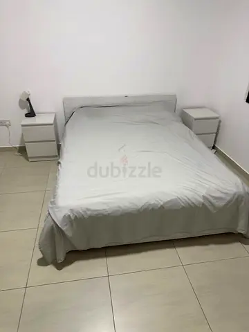 Queen size bed with mattress and two bedside tables - simple white set