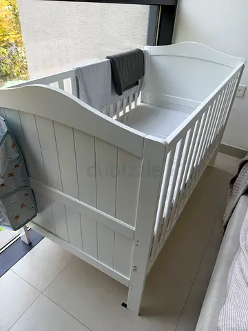 White wooden baby crib