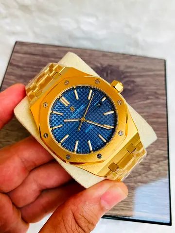 The featured timepiece appears to be an Audemars Piguet Royal automatic 42 mm Oak Selfwinding in yel
