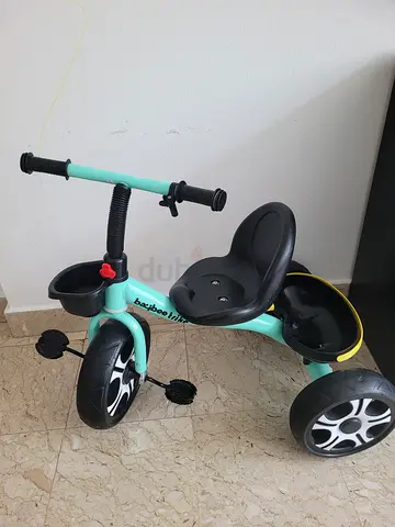 Mint green toddler tricycle with push handle and pedals