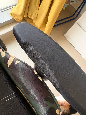Used gaming chair with torn armrest — needs repair.