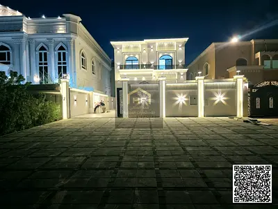 Luxury residential/commercial villa for sale in Al Muwaihat 1, with an outdoor majlis and 20-meter front parking space. The price includes electricity
