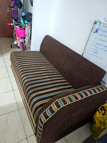 Brown striped two-seater sofa in good condition