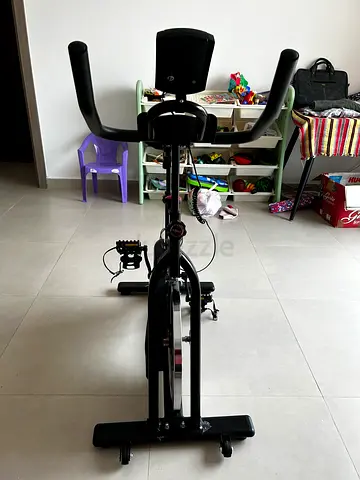 Used upright exercise bike with fixed pedals and console - good condition