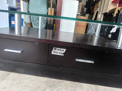 Dark wood TV stand / entertainment unit with glass top and drawers