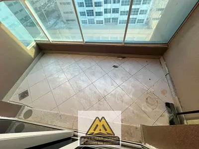 Two bedrooms, a living room with a balcony, a laundry room, and parking in Al Rashidiya 3, near the