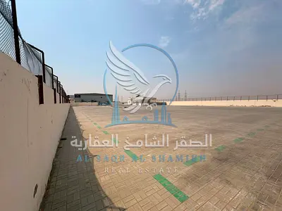For Rent: 60,000 Sq Ft Yard in Al Sajaa, Fully Interlocked, with Bathrooms, Offices, Kitchen, Covered Area & 50KW Electricity, suitable for storage an
