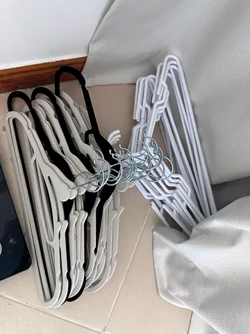 Set of 40+ slim plastic clothes hangers (white & black) - excellent condition