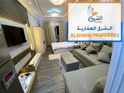 Furnished studio apartment for annual rent – ​​with a balcony, open view, and two private parking spaces – Garden City Towers, prime location at a rea