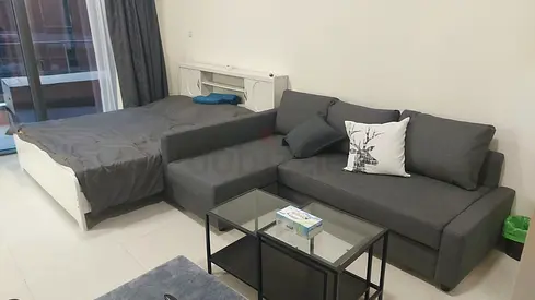 Grey L-shaped sofa with glass coffee table and bed - Good condition