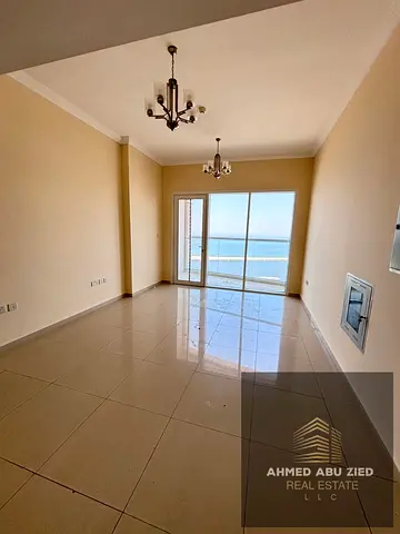 Two bedrooms and a living room with a distinctive sea view, in a strategic location opposite Ajman Port, with two master bedrooms, built-in wardrobes,