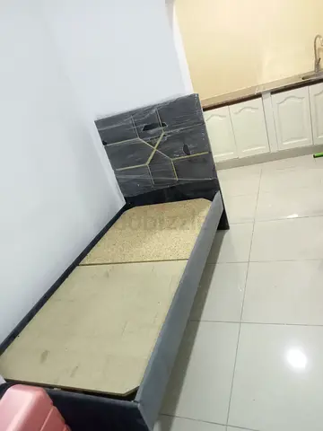 Single bed frame with cushioned headboard