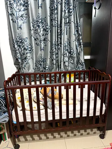 Wooden baby crib with mattress- good condition and very less used. Height adjustable and with wheels