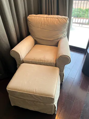 Beige oversized rocking armchair with matching ottoman - good condition
