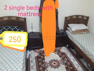 Urgently want to sell!!!Two single wooden beds with mattresses and can be converted into bunk bed.