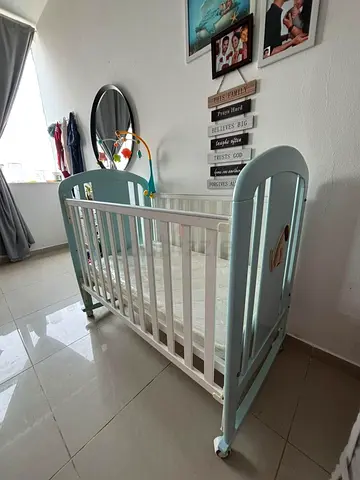 Wooden baby crib in good condition with mattress