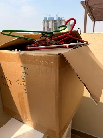 Box of assorted plastic clothes hangers - used