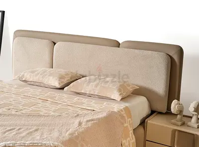 Beige upholstered double bed with padded headboard