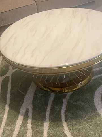Round marble-top coffee table with metal base