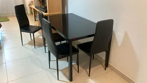 Black glass-top dining table with 4 chairs - compact set