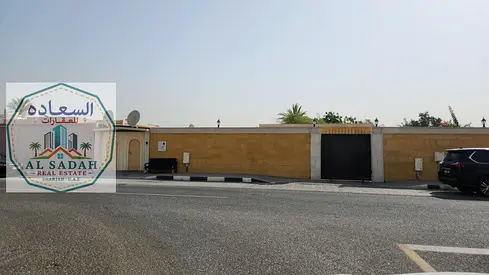 For sale: A house in Al Jazat, divided into two sections. The first section has 6 rooms, a living room, a majlis (formal sitting room), and two kitchens. The second section has 3 rooms, a living room,
