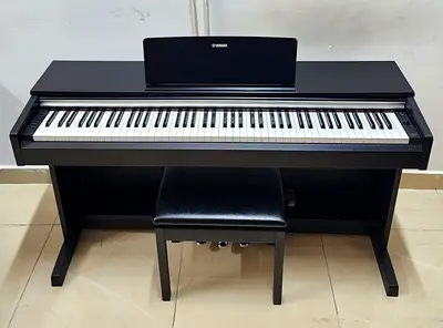 The Yamaha Arius YDP-142B is an 88-key home digital piano featuring a black walnut finish, Graded