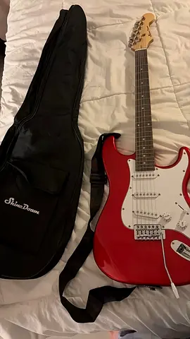 Red electric guitar with gig bag - playable starter kit
