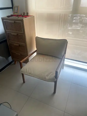 Mid-century style wooden lounge chair with cream cushions